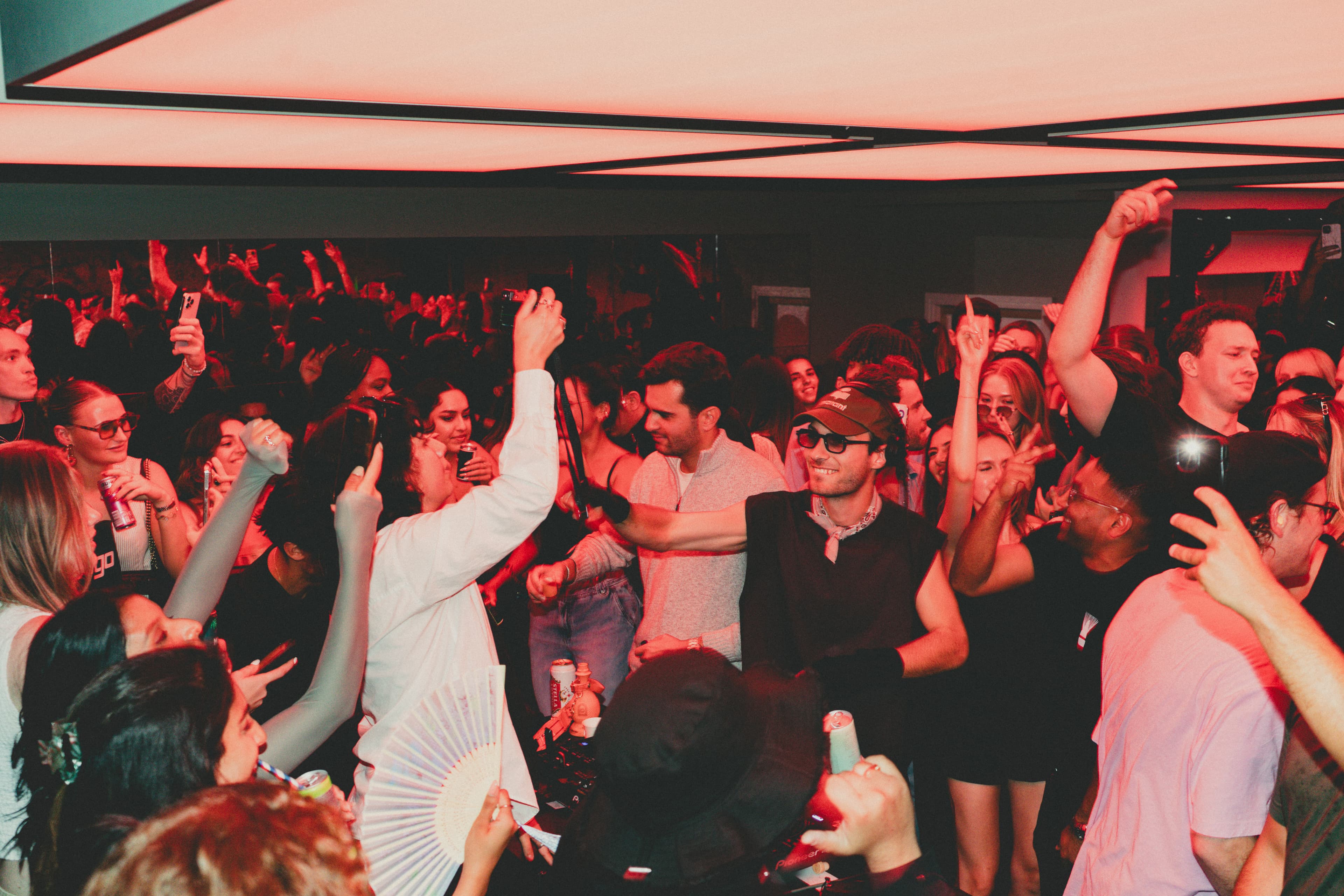 Crowd under red lights at a BuddhaBox night